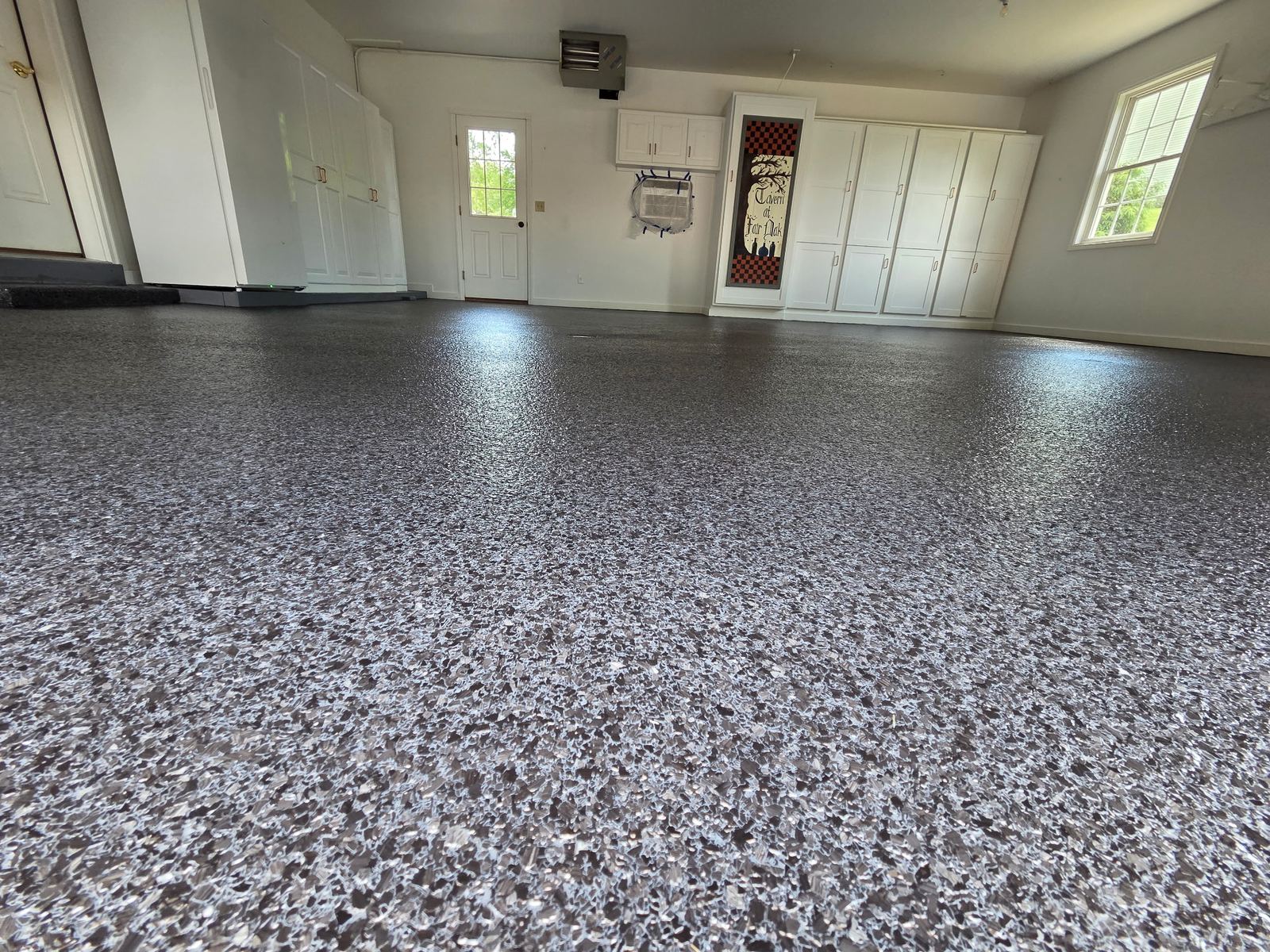 Grey and white flake floor in a finished residential garage