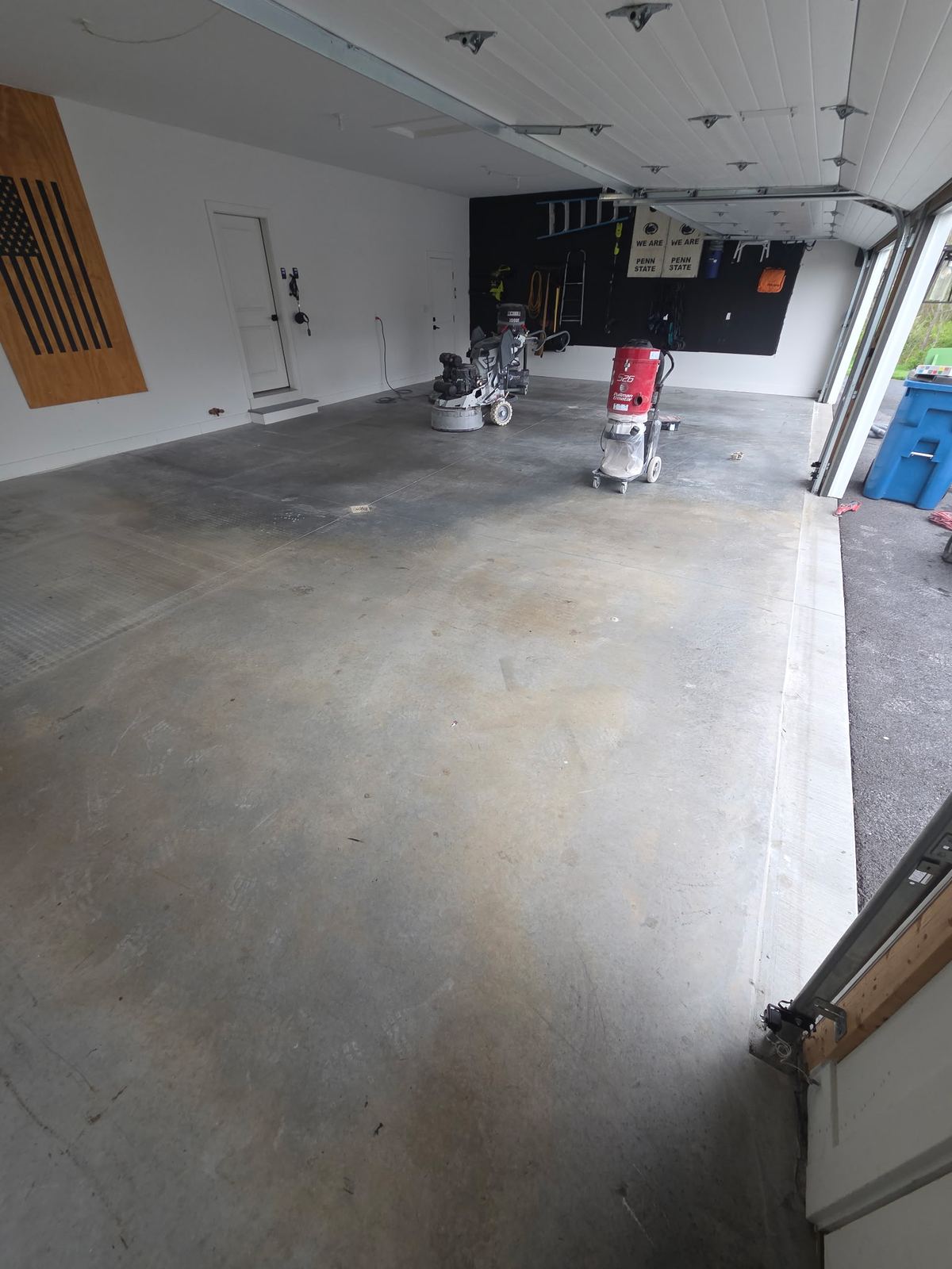 Floor machines and dust extractors set up in a garage between coats