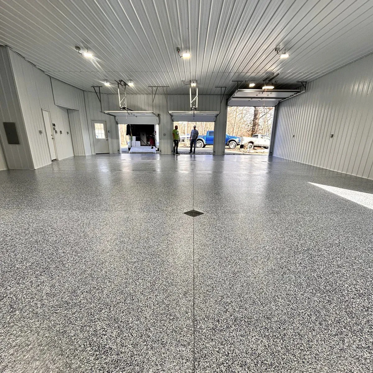 The same shop floor after a full-broadcast gray flake coating